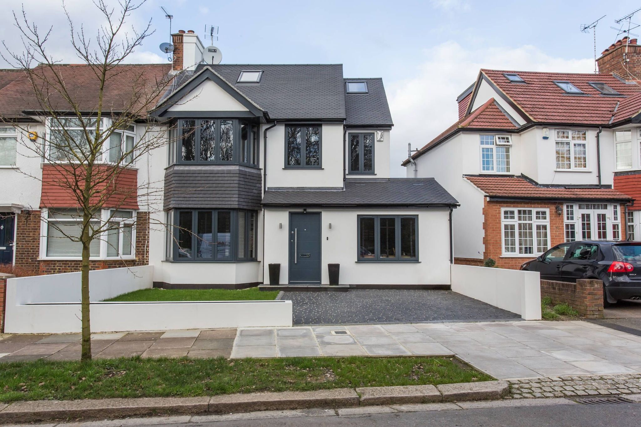 Anthracite windows on a white rendered house